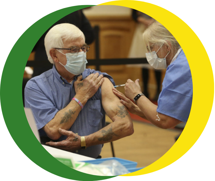A health and care professional delivers a vaccination to a patient