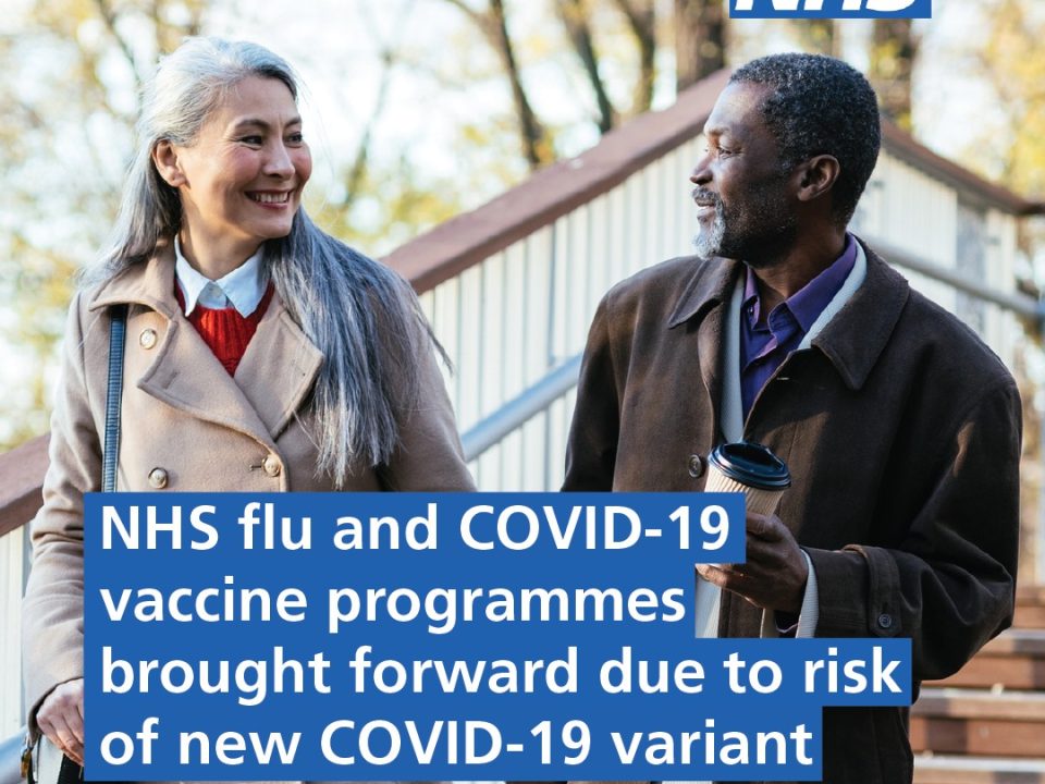NHS flu and COVID vaccine programme brought forward - a picture of a man and woman walking outside together
