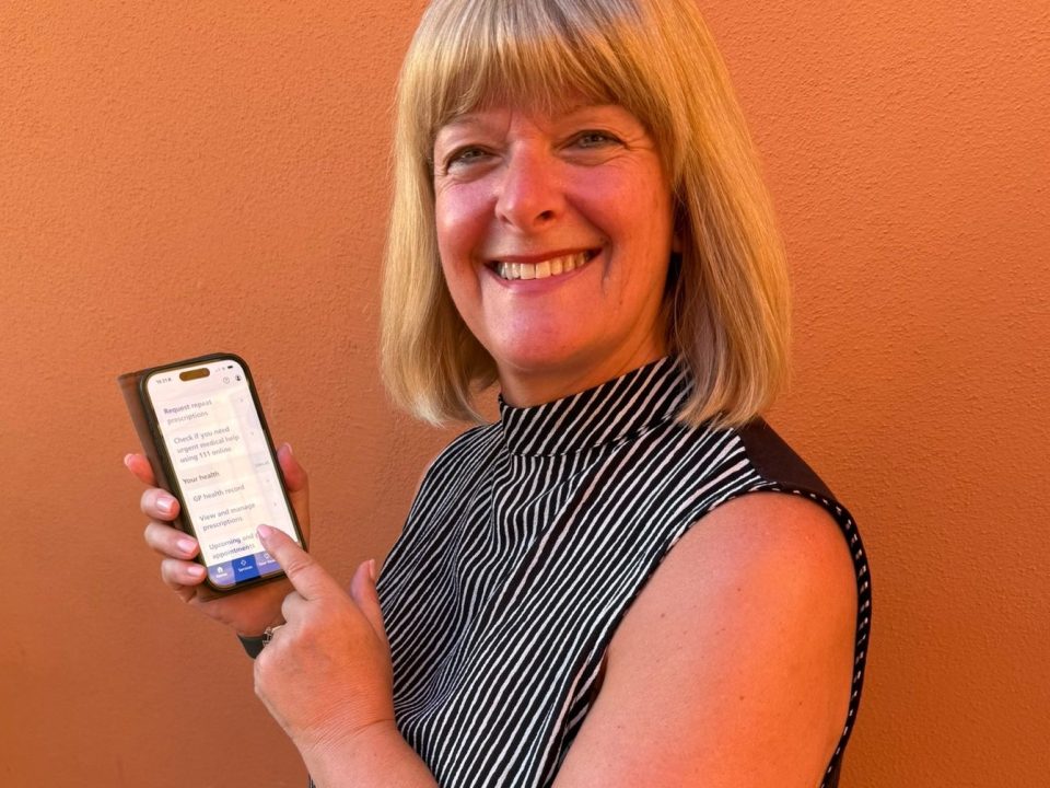 NHS app user Jayne Birch-Jones holding her smartphone