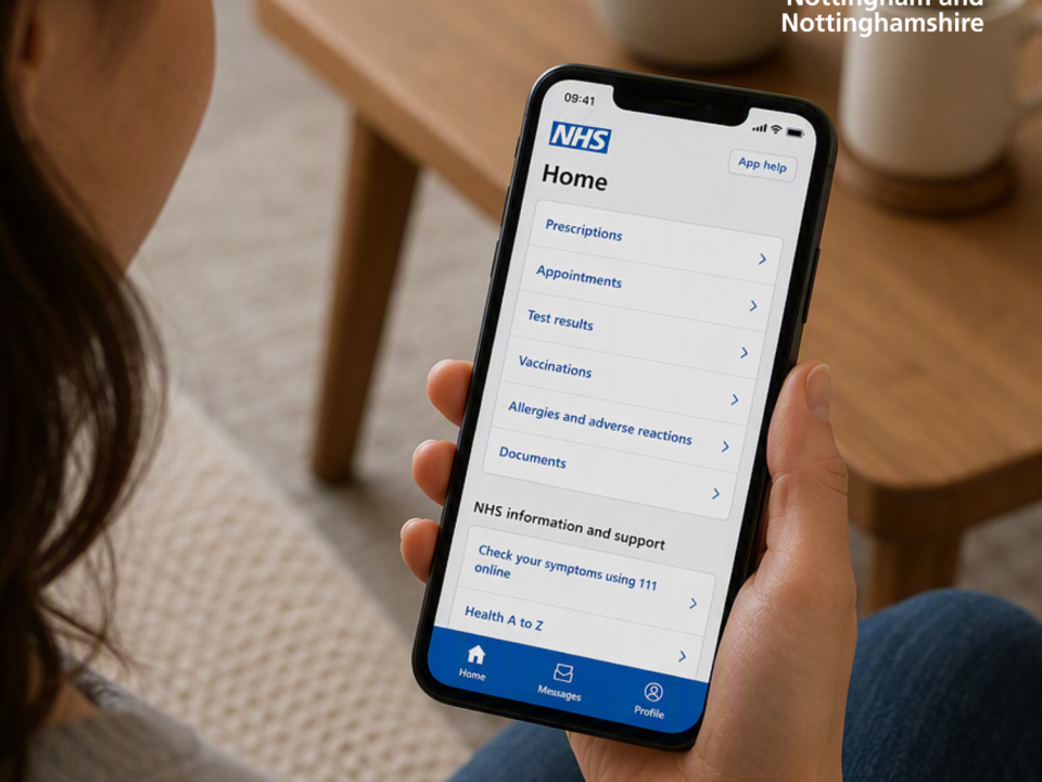 Woman looking at NHS app on her mobile phone